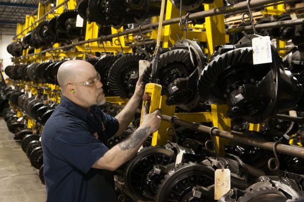 H&H Truck Parts employee hanging an RSP40 reman differently on rack for re-sale