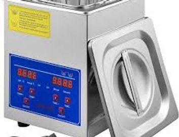 Digital ultrasonic cleaner with control panel and lid.