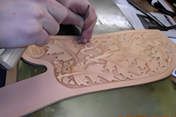 A man stitching saddle