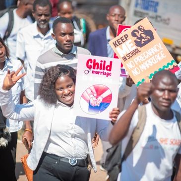 People protesting against child marriage and advocating for no pregnancy in school.