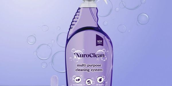 Purple NuroClean multi-purpose cleaner bottle with bubbles on a light purple background.