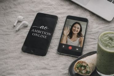 Two smartphones on a table, one with a video call and the other displaying 'Ambition Online'.