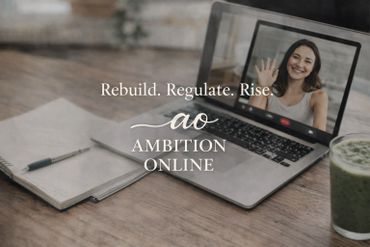 A woman waves on a laptop screen during a video call, next to a notebook and green smoothie.