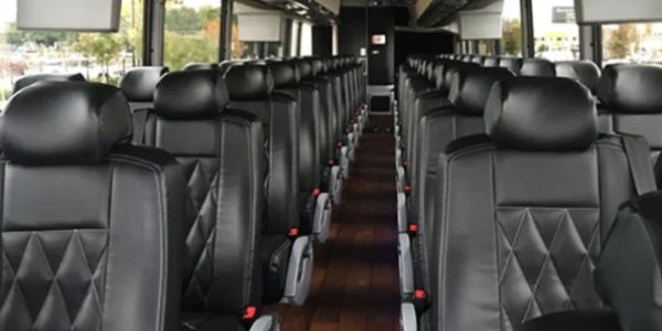 Interior of a luxury bus with black leather seats.