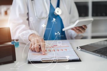 dressed in a white lab coat, suggesting a medical professional such as a doctor or nurse.