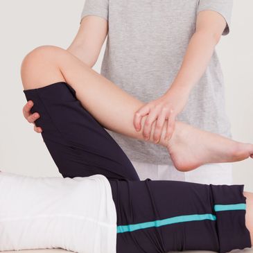 Therapist stretching a person's leg