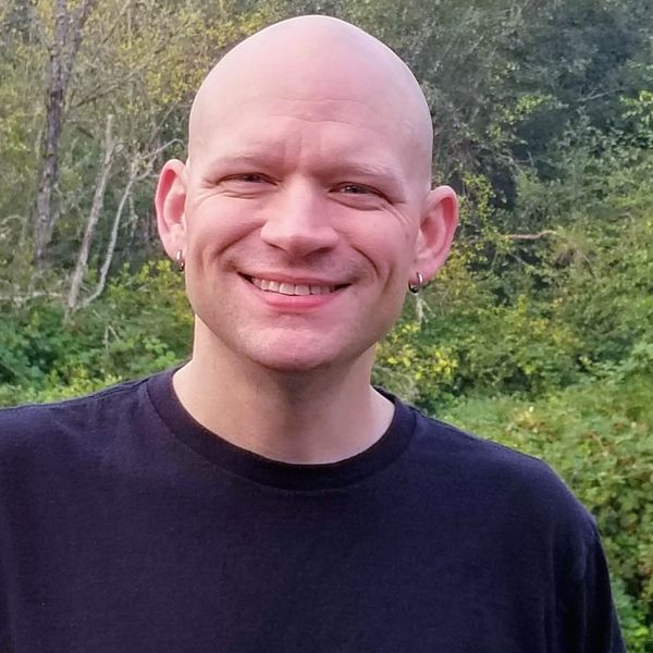 Outdoor photo of Jay Davidson, a warm and experienced massage therapist with a warm and friendly smi