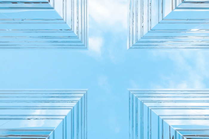 4 corners of 4 buildings symbolize the Company name