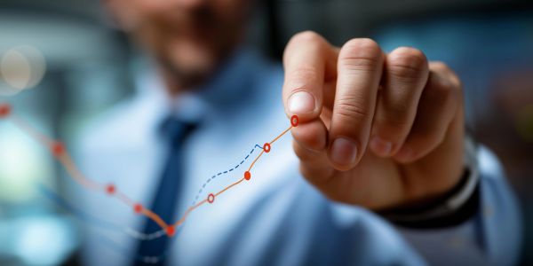 Businessman drawing a rising graph trend. Ongoing Investment Management.