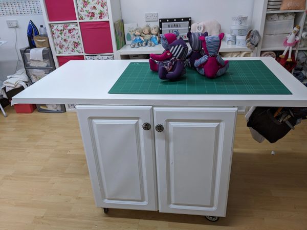 Inside momma bear creates workshop, showing cutting table & four finished memory bears 