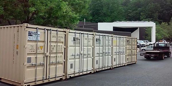 8 x 20 foot CONEX seabox shipping storage containers in a row in a lot. 