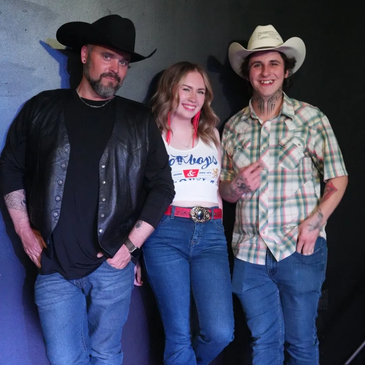 Three people posing in casual western wear and cowboy hats.
