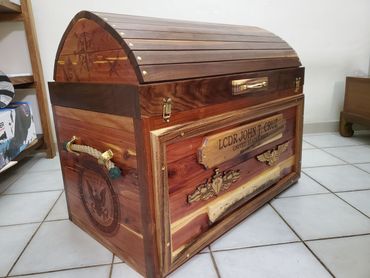 Finished wooden chest with an arched lid.