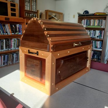 Side view of an arched-lid wooden chest in the workshop.