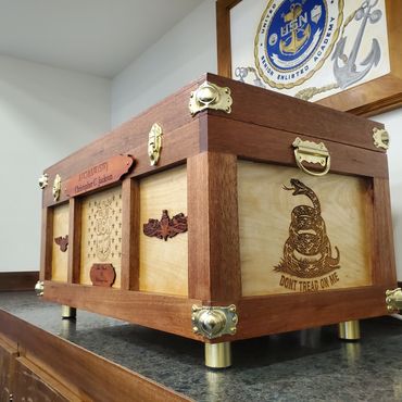 Engraved retirement chest with brass-colored hardware.