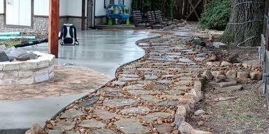 flagstone; mortar; flower bed; stone; rock; stained concrete; walkway; patio