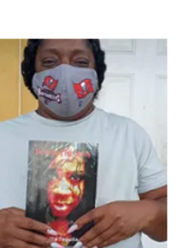 African American woman holding book written by self-published Author