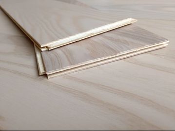 Close-up of wooden flooring panels with interlocking edges.