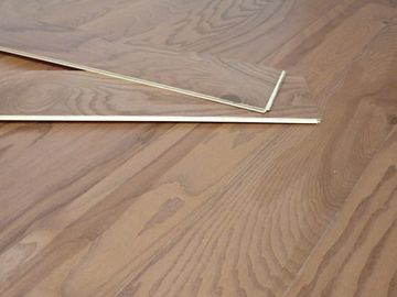 Two wooden sticks on a wooden surface, one bent at an angle.