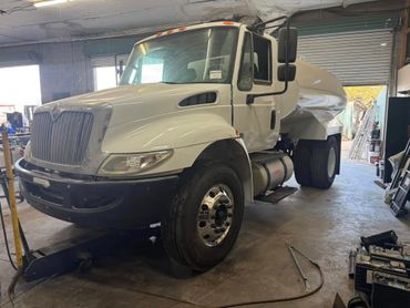 A white truck is parked in the garage.