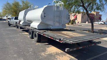 A truck with two large tanks on the back of it.