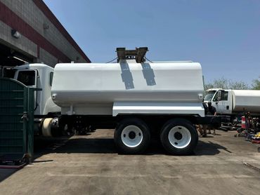 A white truck parked in front of a building.