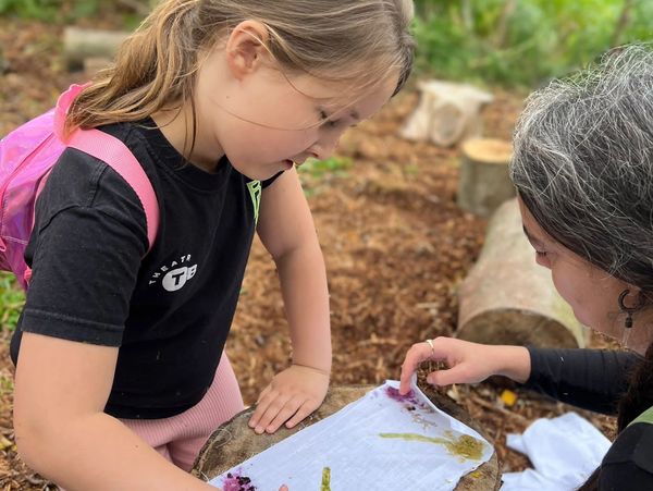 Speech and language therapist and child making nature crafts