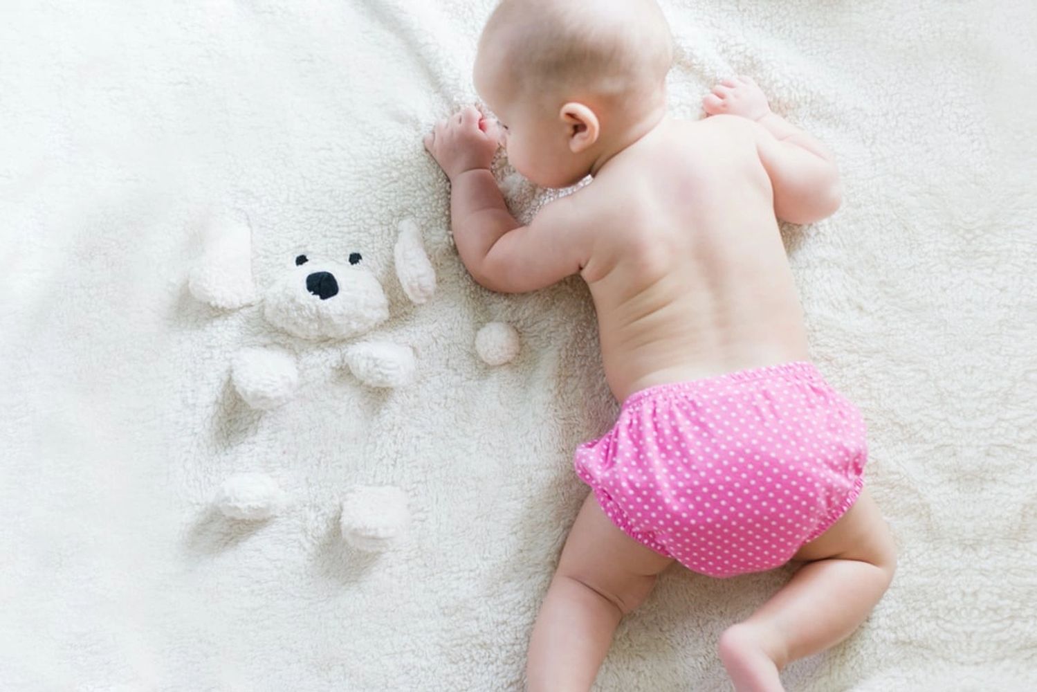 Newborn child relaxing in bed