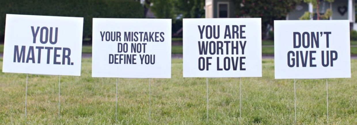 Positive motivational signs in a yard.