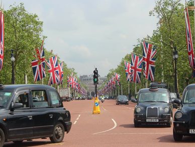 The Mall, black cabs, London. union flags for King Charles III