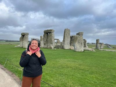 Smiling woman in front of Stonehenge.