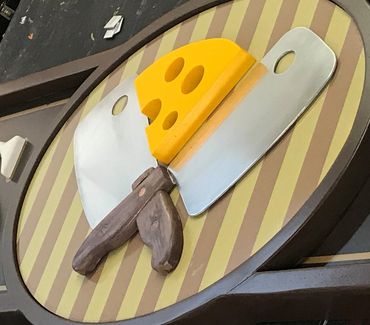 The center piece for Smiley Brothers Foods.   Hand carved cheese slice and handles.  The blades are