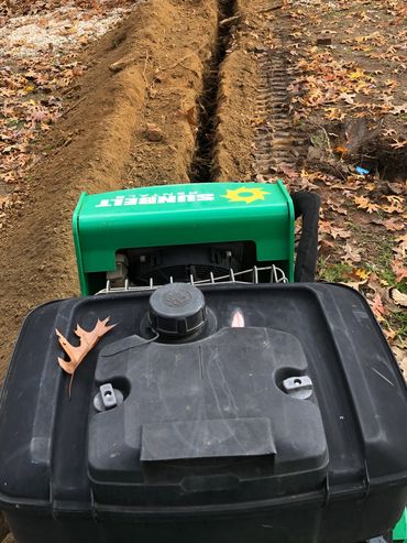 Trenching a circuit to a shed.
