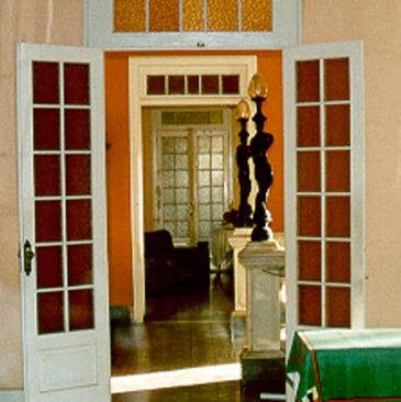 Foto interna do Hotel Valenciano, mostrando o hall de entrada, visto de outro aposento.