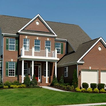Large brown multi-story suburban home.