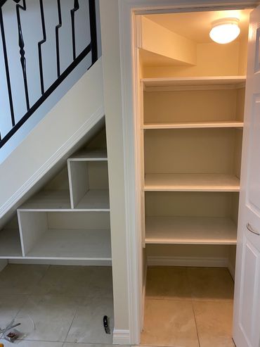 Custom built under the stairs shelving