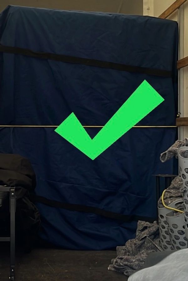 Large object covered with blue fabric and a green checkmark overlay.