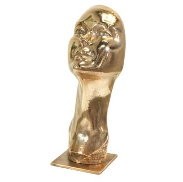 Shiny gold sculpture of a human head on a square base.