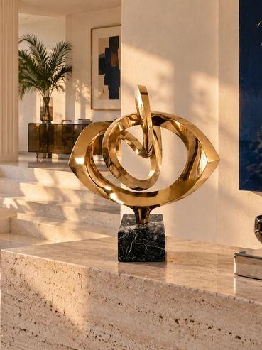 Robert Mitchell’s abstract bronze sculpture Rhythm displayed in a light-filled 1970s Palm Beach mode