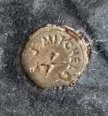 Close-up of the bronze seal beneath Robert J. Mitchell’s Rhythm, showing the MITCHELL marking and ed