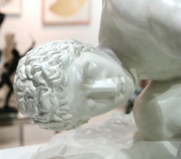 Close-up of a classical marble sculpture's head and upper torso.