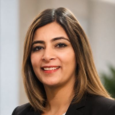 Professional woman smiling in a business setting.