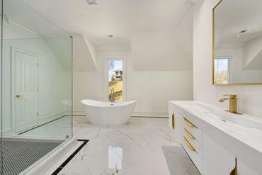 Clean white bathroom with gold accents