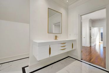 Clean white bathroom with gold accents