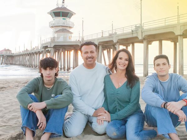 Chef Dino, his wife Lisa and their two sons Caleb and Joshua in front of the Huntington Beach Pier.