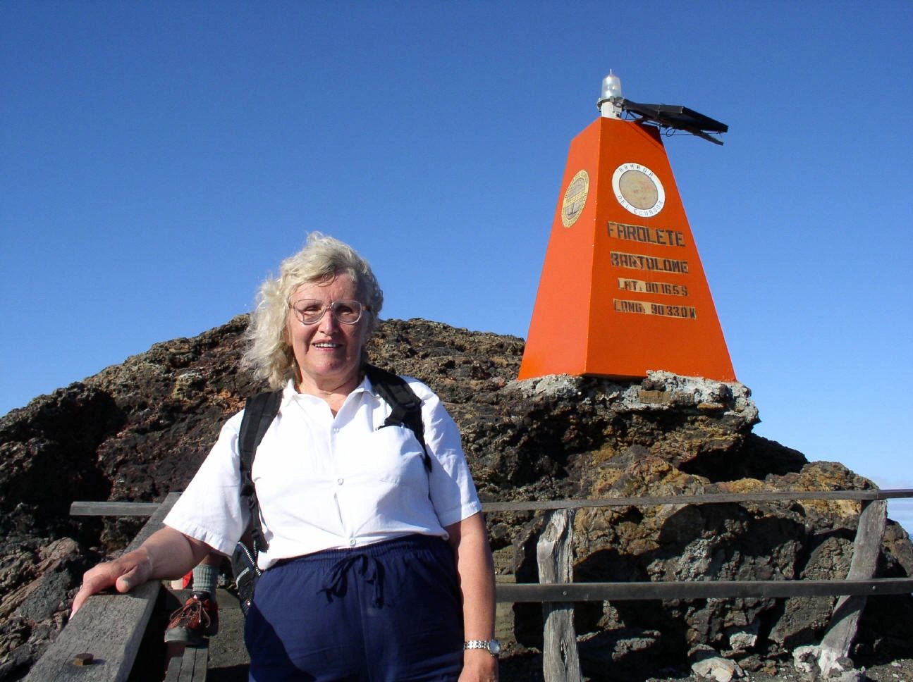 Carol Kender at the marker on the Galapagos Islands 