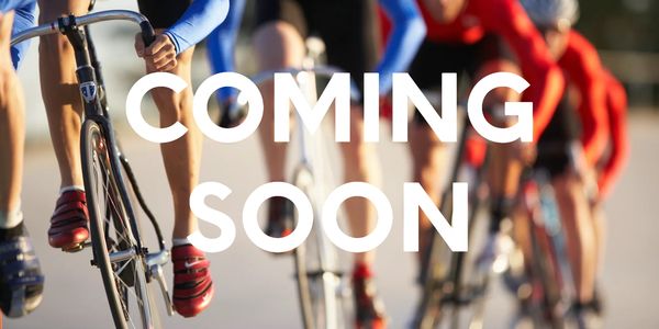A group of cyclists riding fast with the words 'coming soon' across the image