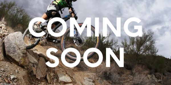 A person riding a mountain bike with the words 'coming soon'