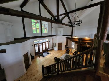 Restored interior beams of a Muskoka home with professional media blasting and staining as part of a log home restoration.