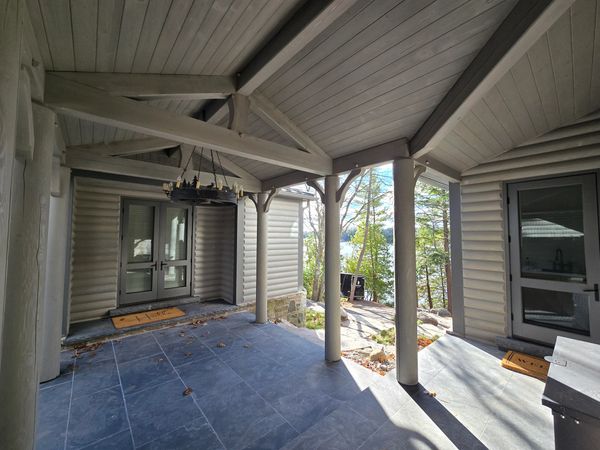 Log Home Restoration in Ontario- Exterior porch fully restored.